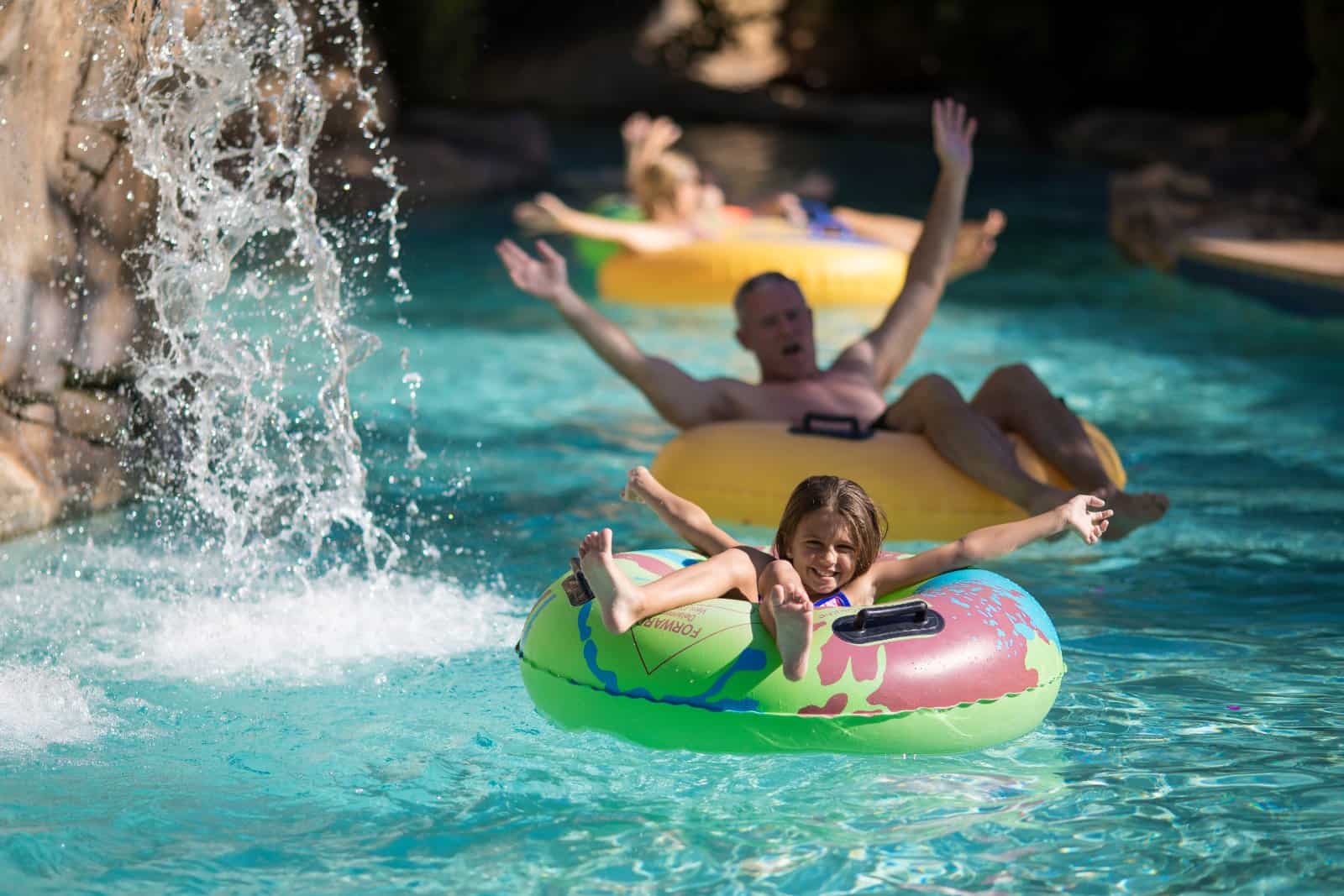 Father and daughter riding in tubes on a lazy river ride at the Eagle Trace water park.