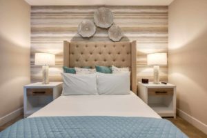 Large king bed with plush headboard and tropical shell decorations in an Eagle Trace resort residence.